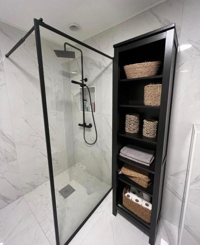 a shower in a bathroom with a glass shower at Wonderful Seaview Apartment in Tromsø