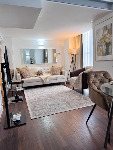 a living room with a couch and a table at Luxury 2Bed, 2Bath Flat in Greenwich London in Woolwich