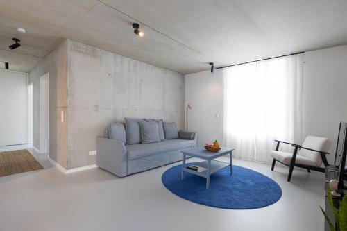 a living room with a couch and a table at Weinberg-Design-Apartment Stuttgart-Fellbach in Fellbach