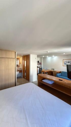 a bedroom with a large bed and a living room at 1506 - Blue Tree Towers in Fortaleza