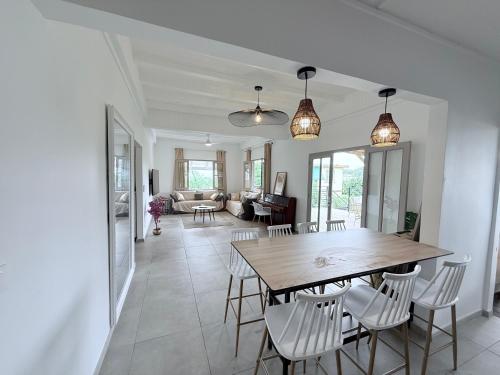 a dining room and living room with a table and chairs at Villa Mamina Martinique in Fort-de-France
