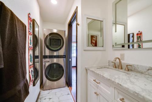 a bathroom with a washer and dryer next to a sink at Less Than 1 Mi to Santa Fe Plaza Mtn-View Gem with Hot Tub! in Santa Fe