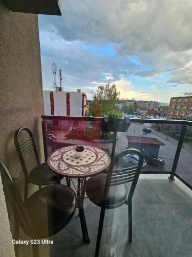 a table and chairs on a balcony with a view at Apartman Milja in Požega