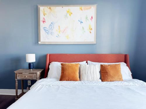 a bedroom with a bed with a blue wall at The Washington Apartments in Evansville