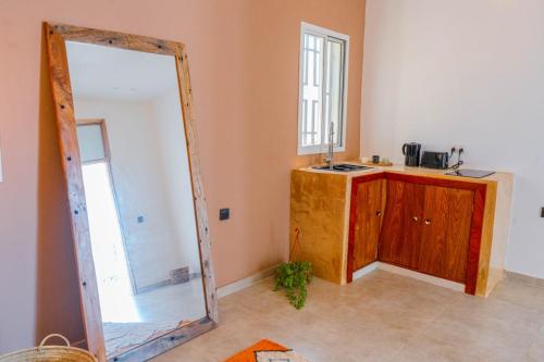 a mirror in a room with a sink and a counter at Mayssa Villa in Paje