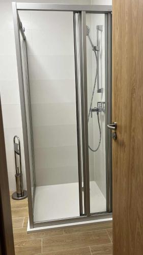 a shower with a glass door in a bathroom at BiQuarters in Košice