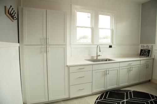 a kitchen with white cabinets and a sink and a window at 718 Morgan Ave in Harriman