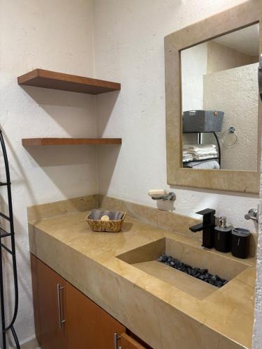 a bathroom counter with a sink and a mirror at Luxurious house in Puebla in Tlazcalancingo
