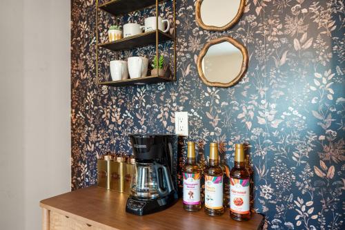 a counter with a coffee maker and bottles of beer at Lovely 1 BR APT in Moncton