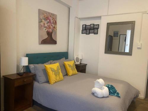 a bedroom with a bed with a stuffed animal on it at Home Estudio 3 in Santiago