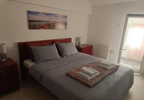 a bedroom with a bed with two towels on it at Zemun Central in Zemun