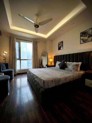 a bedroom with a bed and a ceiling fan at Elysium in Islamabad