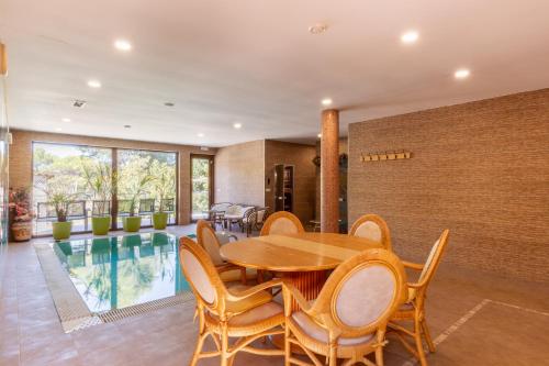 a dining room with a table and chairs and a pool at Casa Navajas in Jérica