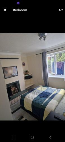 a bedroom with a bed and a window at Andrea house in Thornton Heath