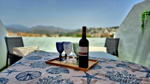a bottle of wine sitting on a table with glasses at Apartamento Alcazar in Almuñécar
