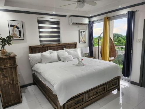a bedroom with a large bed and a large window at Modern Kingston Condo with Rooftop Pool and View in Kingston