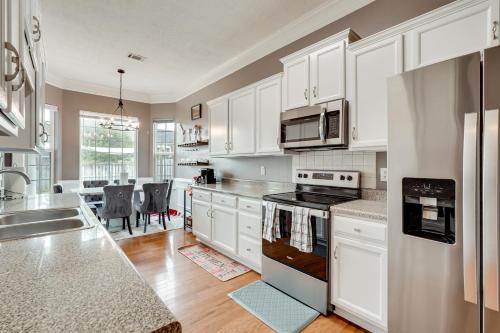 a kitchen with white cabinets and a counter top at 14 Mi to Augusta! Family Home with Pet-Friendly Yard in Evans