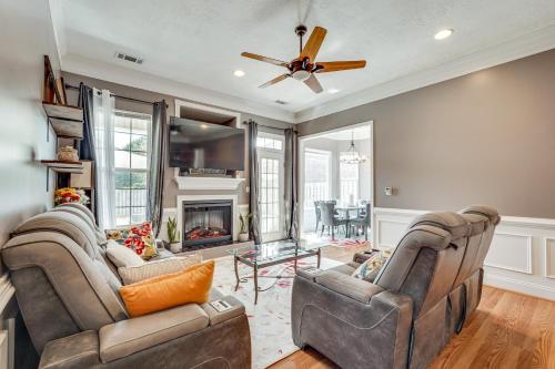 a living room with two chairs and a fireplace at 14 Mi to Augusta! Family Home with Pet-Friendly Yard in Evans