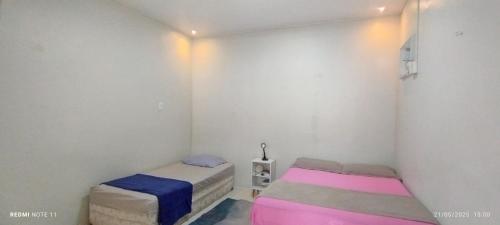 Llit o llits en una habitació de Casa com quartos compartilhados