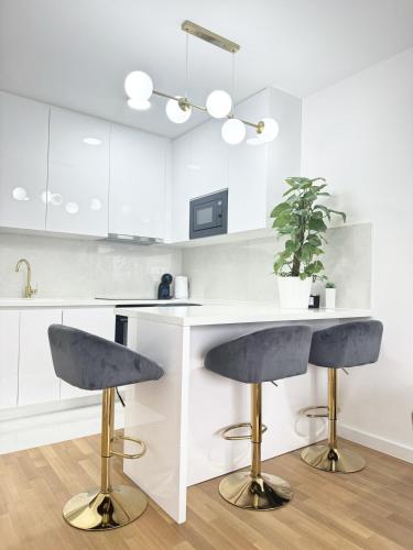 a kitchen with a counter and two bar stools at Apartman Lilly - Zagreb - Mirna Lokacija - Lođa in Zagreb