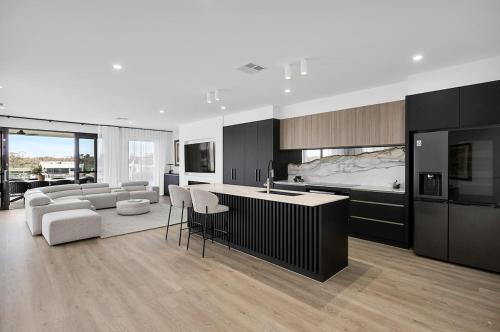 a kitchen and living room with a couch and a table at Miles on the Murray in Mildura