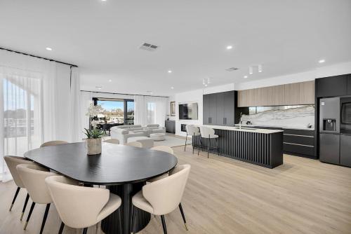 a kitchen and living room with a table and chairs at Miles on the Murray in Mildura