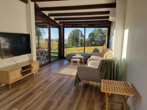 a living room with couches and a flat screen tv at Chalet in Journans