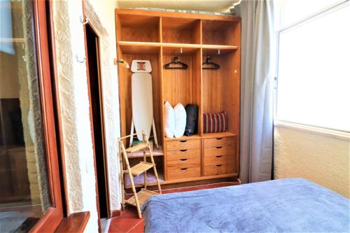 a bedroom with a dresser and a bed in a room at Cosy studio apartment in Vilamoura with AC and Pool! in Quarteira
