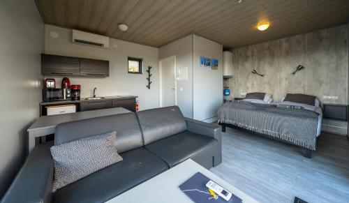 a living room with a couch and a bed at Dis Cottages in Grundarfjordur