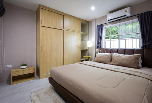 a bedroom with a large bed and a window at Luxury New Villa 2BR Pool near Bangtao Laguna and Beach in Ban Thalat Choeng Thale