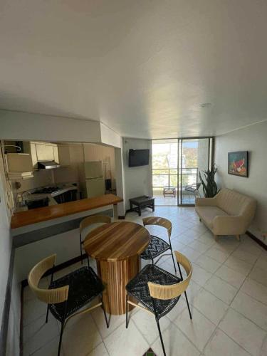 a kitchen and living room with a table and chairs at Alojamientovacacional657 in Rodadero