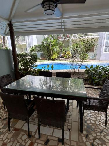 a table with birds sitting on top of it on a patio at Private Condo with Pool in Tamarindo, Guanacaste in Tamarindo