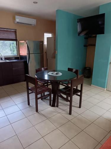 a dining room with a table and chairs and a kitchen at Private Condo with Pool in Tamarindo, Guanacaste in Tamarindo