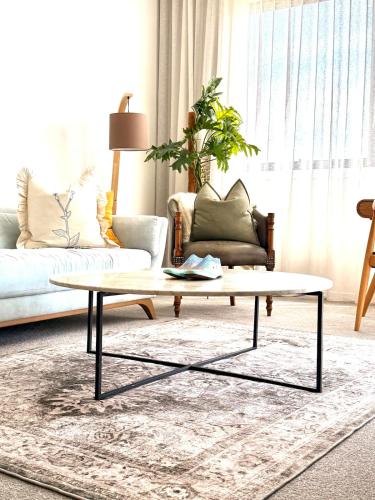 a living room with a coffee table and a couch at Home - Yard Apartment - Googong & Queanbeyan in Letchworth