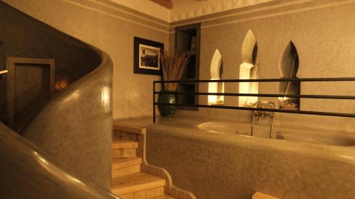 a bathroom with a tub and a sink at Eden Boutique Hotel in Tamellalt
