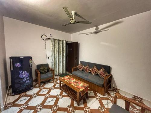 a living room with a couch and a table at Naini Kalsa Stay in Nainital