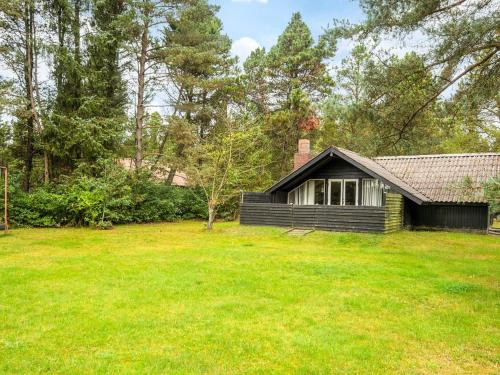 a house with a grass yard in front of it at 4 person holiday home in Oksbøl-By Traum in Oksbøl