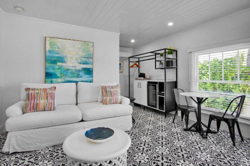 a living room with a white couch and a table at Pelican Post at Anna Maria Island Inn in Bradenton Beach