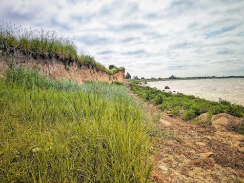 a dirt road next to a body of water at 6 person holiday home in Karrebæksminde-By Traum in Karrebæksminde