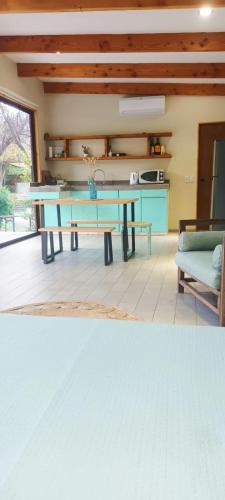 a dining room with a blue table and a couch at Espacio Arenales in Paine