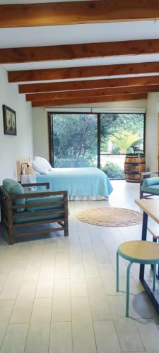 a bedroom with a bed and a large window at Espacio Arenales in Paine