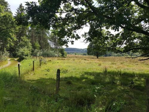 a field with a fence in the grass at 5 person holiday home in Silkeborg in Silkeborg