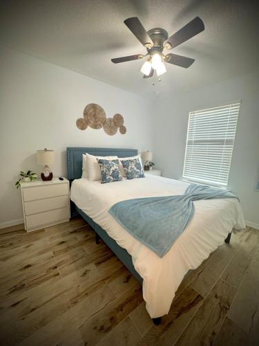 a bedroom with a bed with a ceiling fan at Downtown Historic St Augustine! Quality, Comfort, Hospitality, FUN! putt putt in St. Augustine
