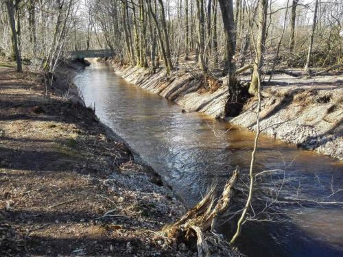a stream of water with a bridge in the background at 5 star holiday home in Ansager-By Traum in Ansager