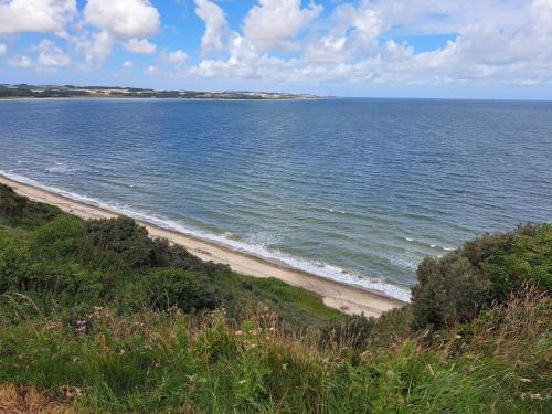 a view of a beach with the ocean at 4 person holiday home in Struer in Struer