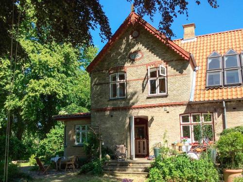 an old brick house with a porch at Spacious Cottage Retreat in Sonderborg-By Traum in Sønderborg