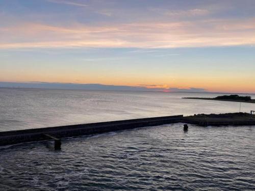 a large body of water with a pier in it at Seaside Charm in Gedser - By Traum Ferienwohnungen in Gedser