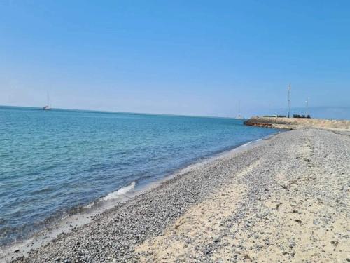 a beach with a rocky shore and the ocean at Seaside Charm in Gedser - By Traum Ferienwohnungen in Gedser