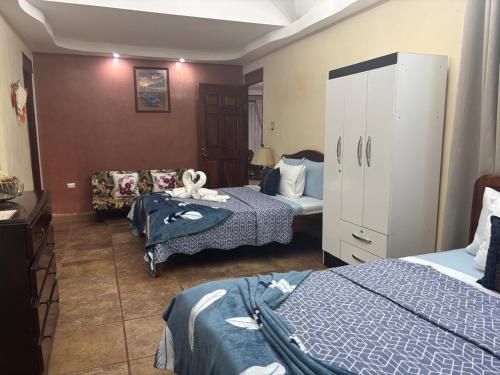 a hotel room with two beds and a couch at Casa Mathi in Portegolpe
