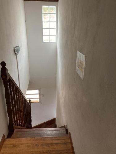 a hallway with a staircase with a window and a stair case at Gîte LEUCALYPTUS in Saint-Paul
